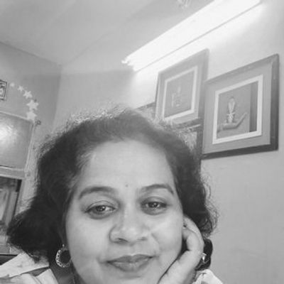 Black and white selfie of a woman smiling gently.