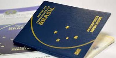 Close-up of Brazilian passports with a dark blue cover and gold lettering.