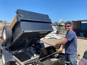 Phot of Joel Flanagan at scrap yard, dumping a load of scrap.