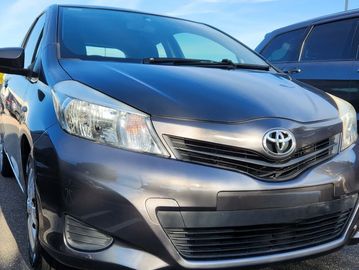 Gray Toyota car parked under a clear blue sky.