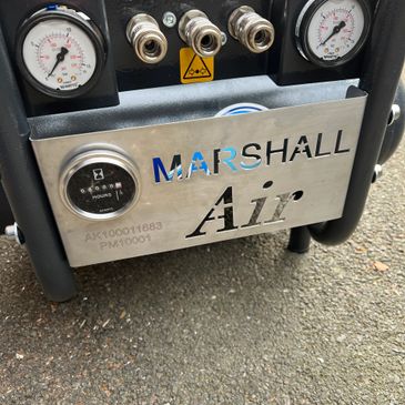 Close-up of Marshall Air equipment with pressure gauges and connectors.