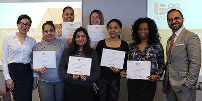 Dr. Bahman Radnejad and Dr. Brenda Nguyen with graduates of a 1388 Consulting leadership development program.