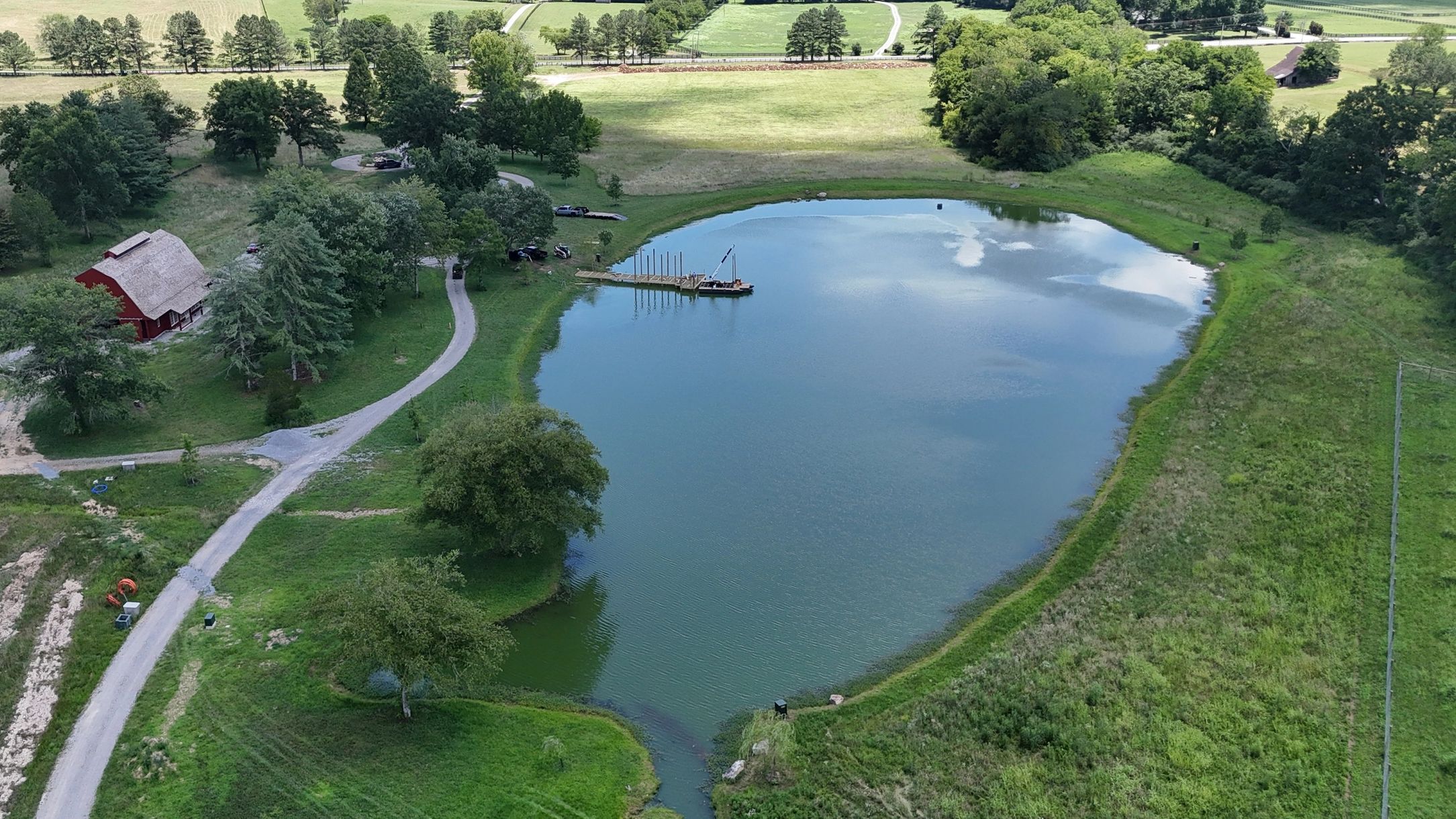 Our specialized barge driving pilings for a stationary dock on a private pond in Leipers Fork, TN