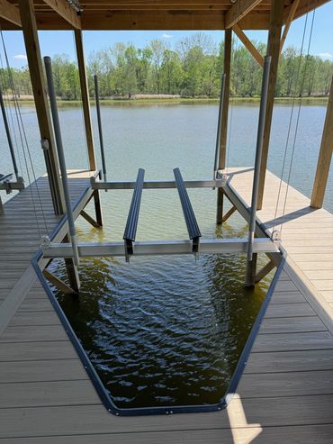 V-hull boat lift with guide poles on the Tennessee River