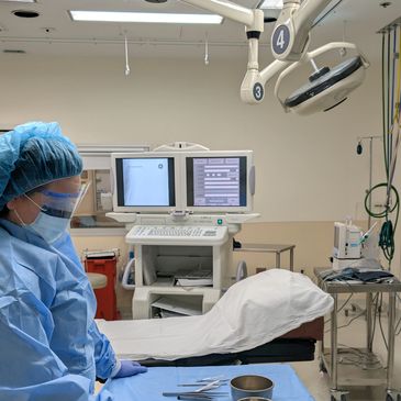 Medical professional prepares surgical instruments in operating room.