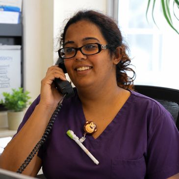 Smiling nurse talking on a phone at work.