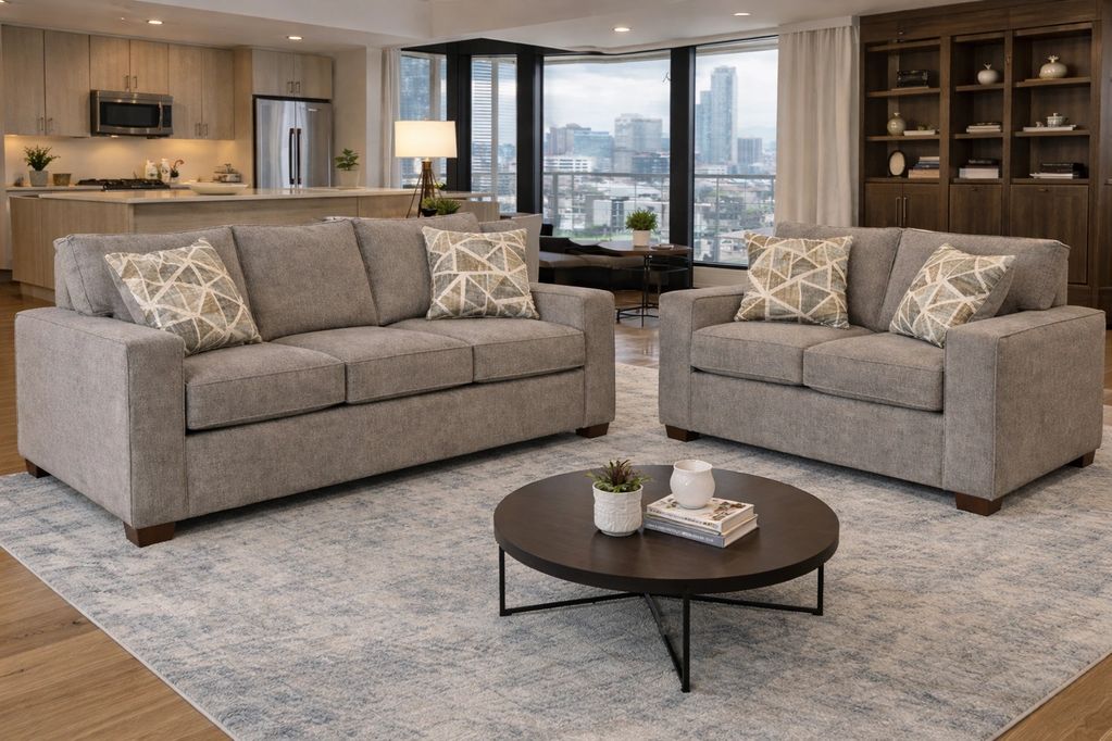 Modern living room with gray sofas and city view.