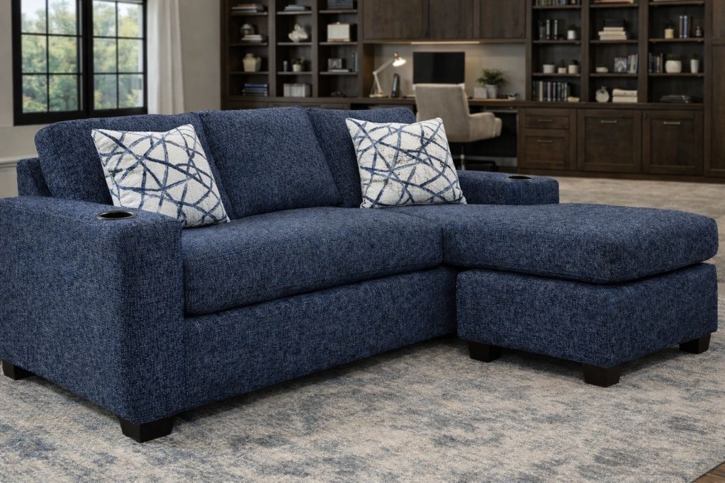 Blue sectional sofa with patterned pillows in a cozy living room.