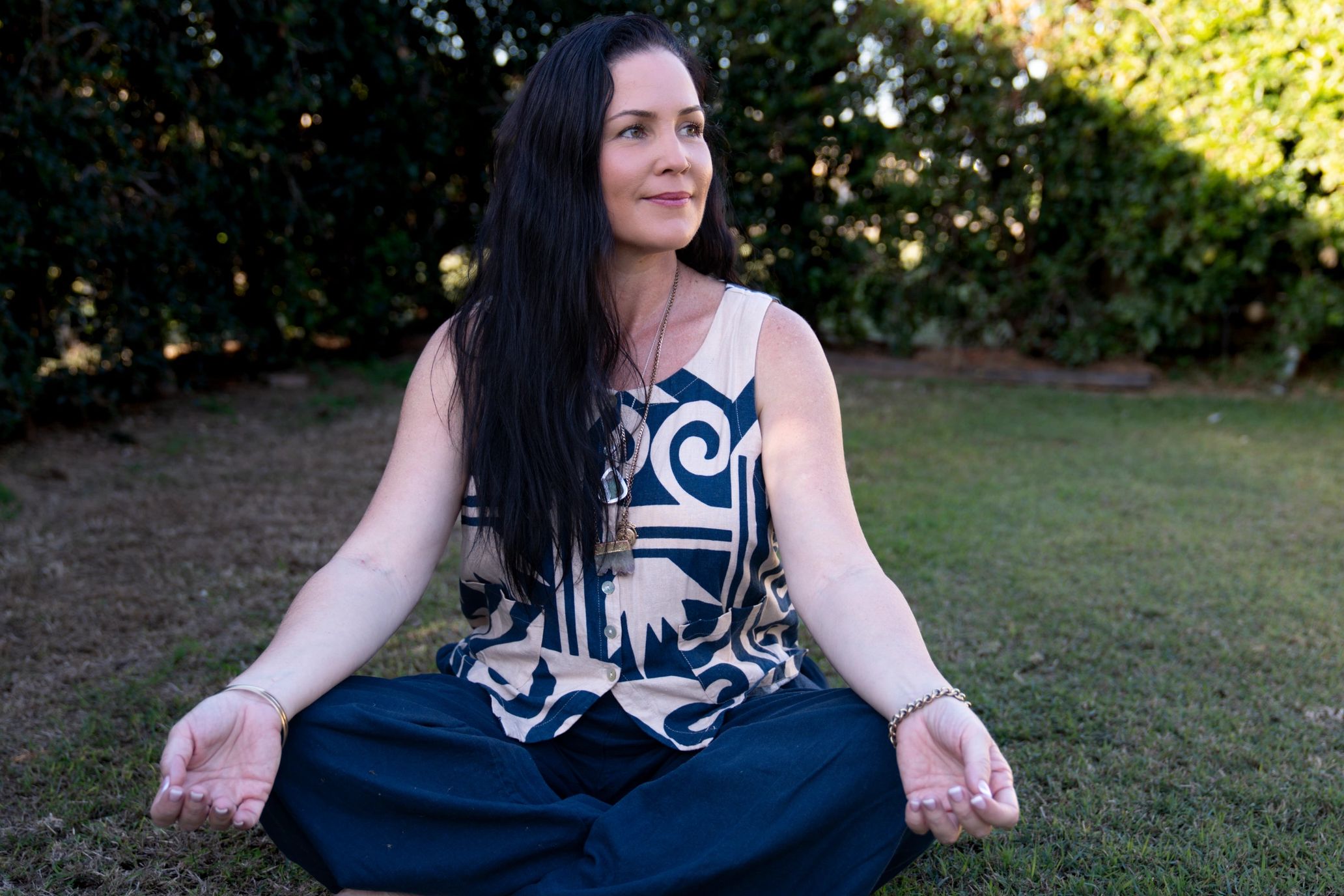 Woman sitting in medative pose while looking away