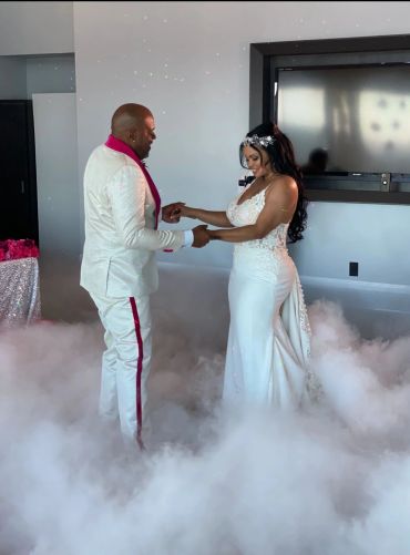 Bride and groom dancing surrounded by fog on their wedding day.