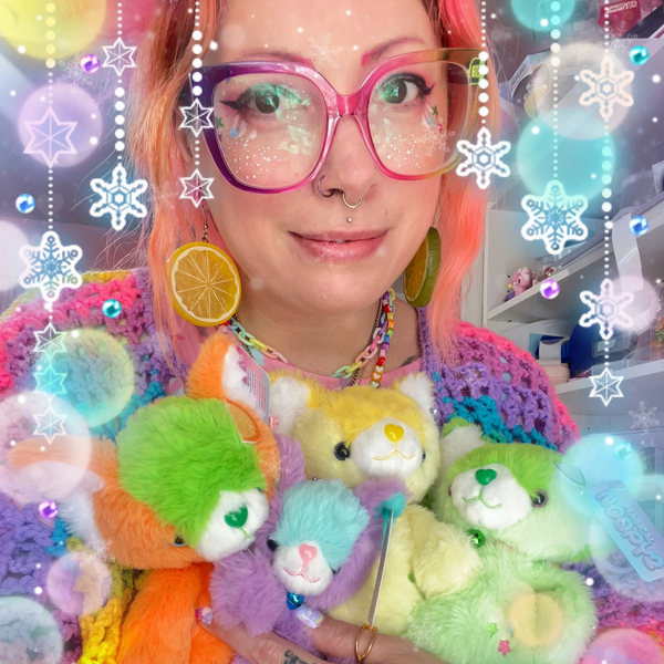 Person with colorful glasses and earrings holding vibrant stuffed animals with decorative snowflakes.