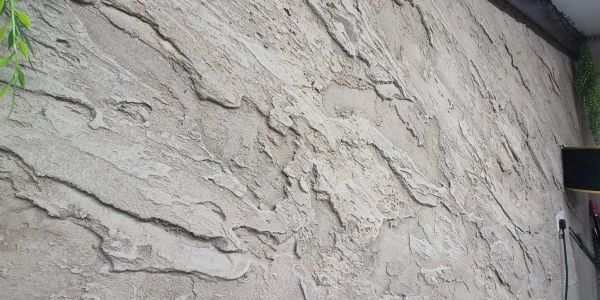 Textured gray stone wall with rough surface.