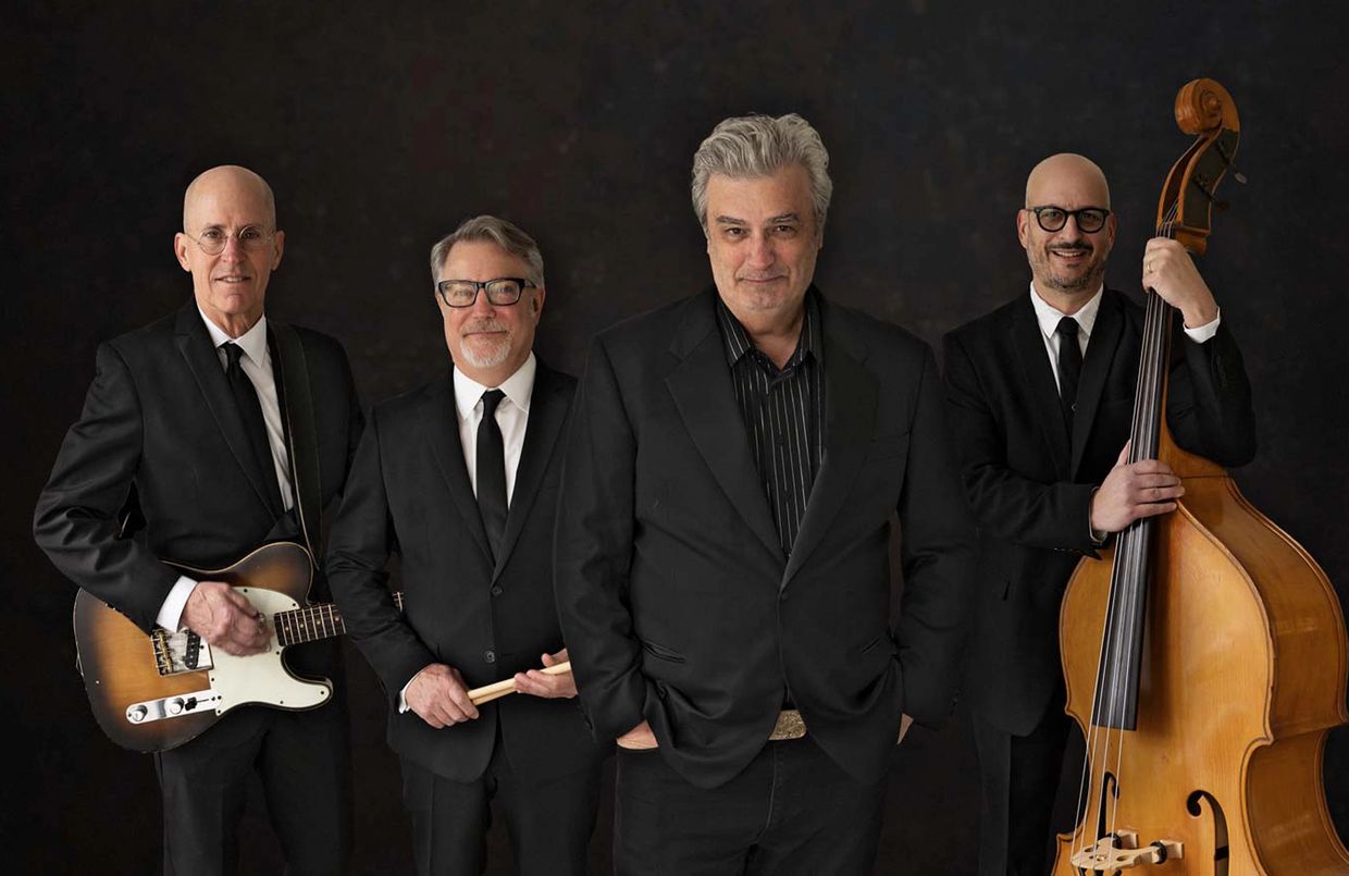 Four men in suits with musical instruments.