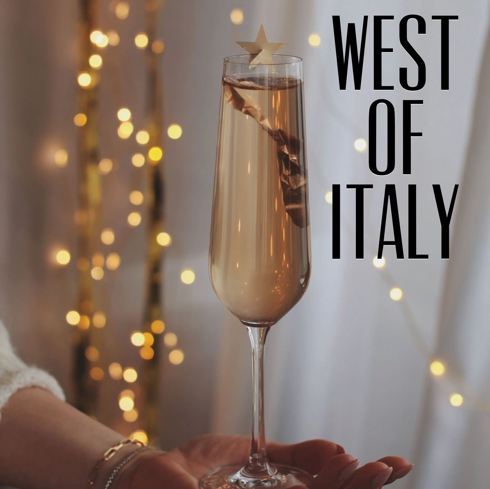 Elegant cocktail with star garnish and festive lights.