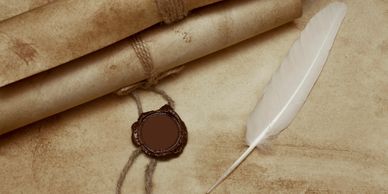 closeup shot of feather and a seal on the paper 