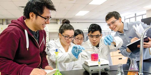 A group of students doing a science lab with a tutor