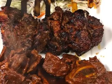 Grilled, marinated beef cuts served on a plate.