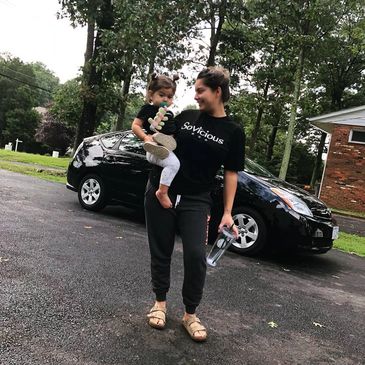 Mother carrying child in sovicious classic tee