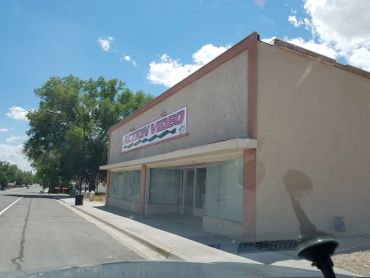 Closed business on a quiet street under a sunny sky.