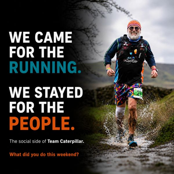 A runner joyfully splashes through a muddy trail, celebrating community and running.