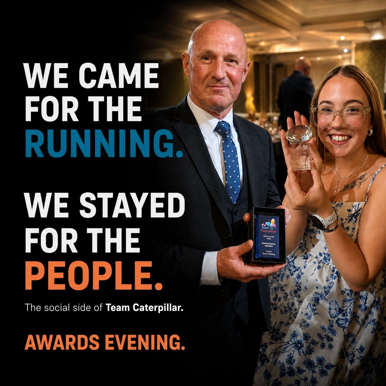 Two people holding awards at a Team Caterpillar awards evening.