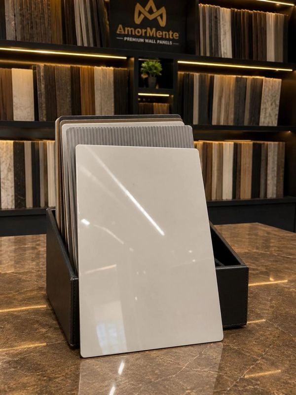 Sample tiles displayed on a table in a showroom.