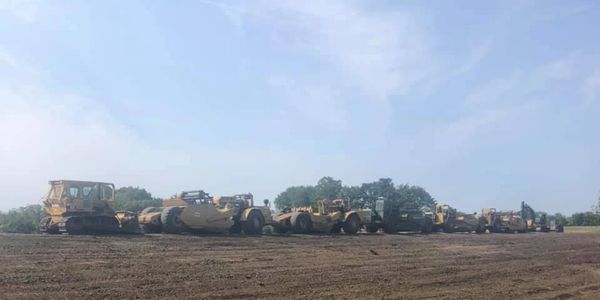 A few excavators in a line