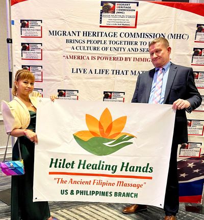 Owners show casing Hilot Healing Hands massage services at Philippines Migrant Heritage Commission.