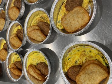 Mission Belly Full meals being prepared for donation.