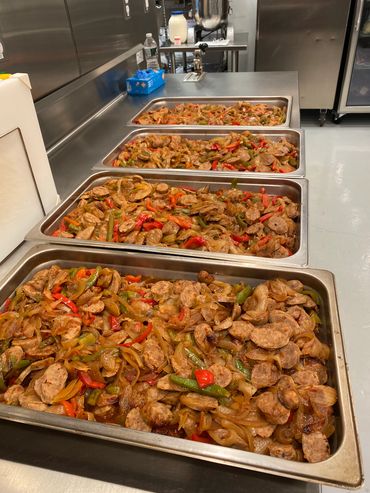 Mission Belly Full meals being prepared for donation.