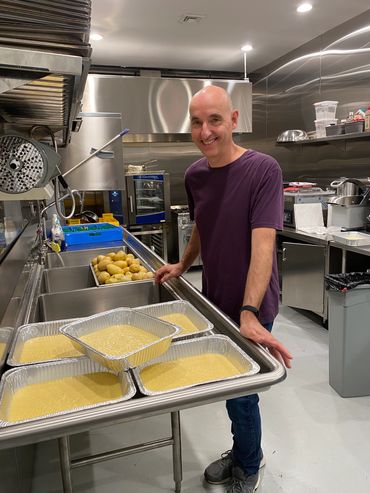 Mission Belly Full meals being prepared for donation by volunteer.