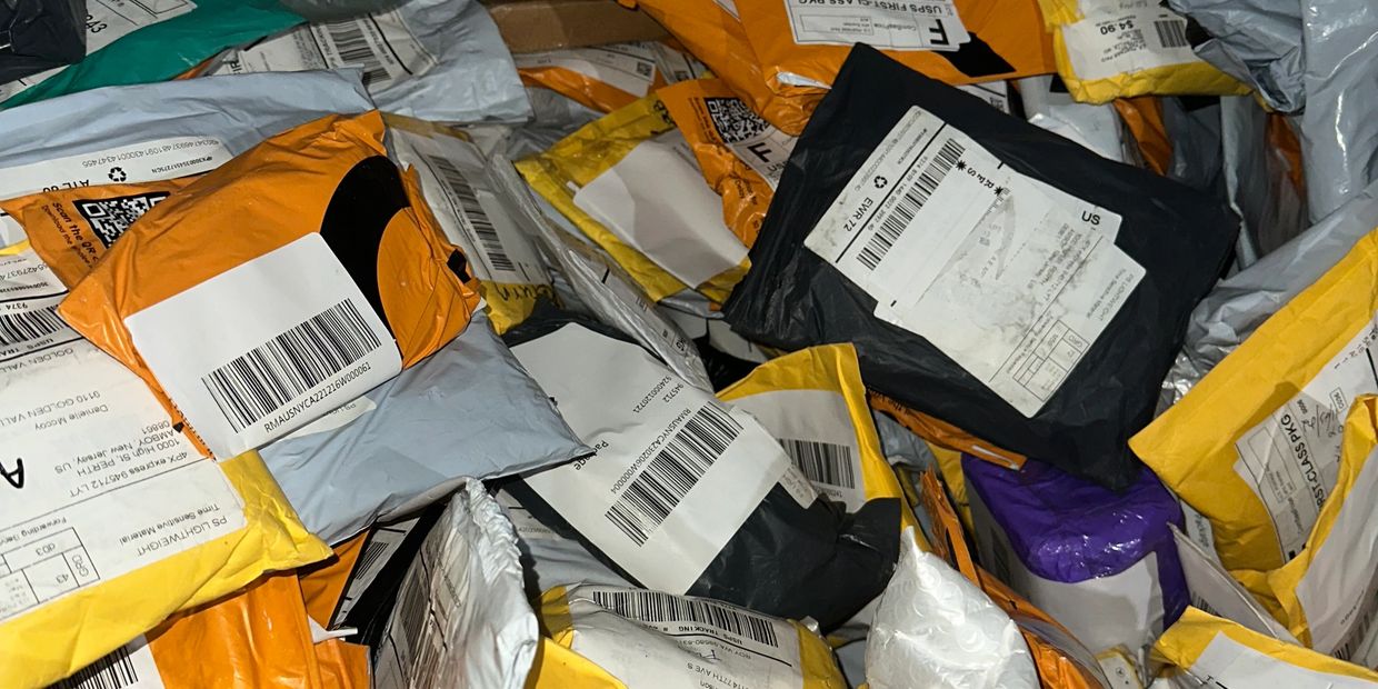 Close-up of unopened unclaimed mail packages