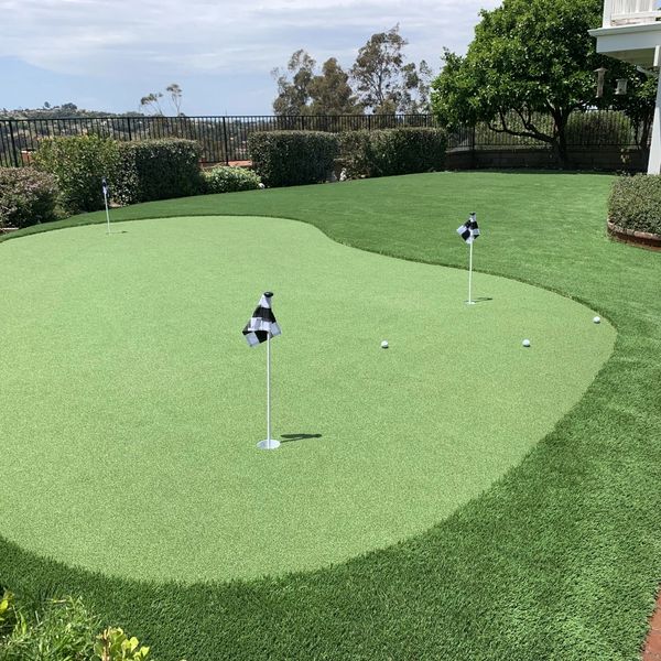 Synthetic turf putting green in rear yard residential