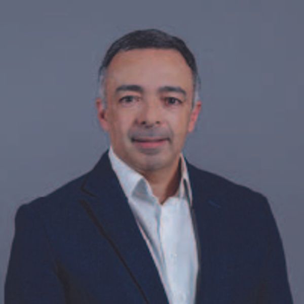 Professional man in a suit with a neutral background.