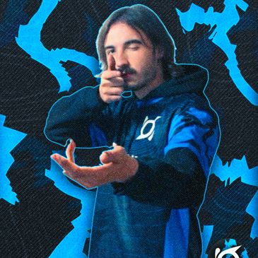 Man in blue hoodie pointing fingers like a gun with a dynamic blue background.