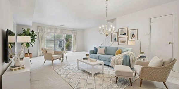 Bright living room with cozy furniture and large window.