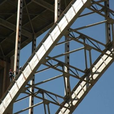 Rope access technicians inspecting a bridge.