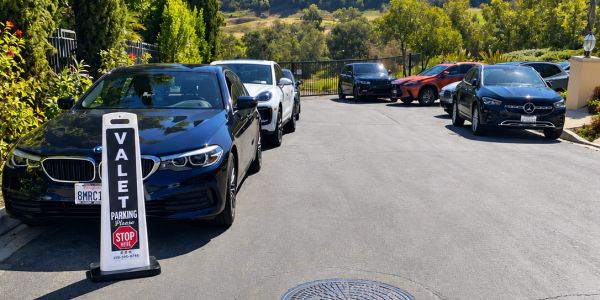 Valet parking area with luxury cars lined up.