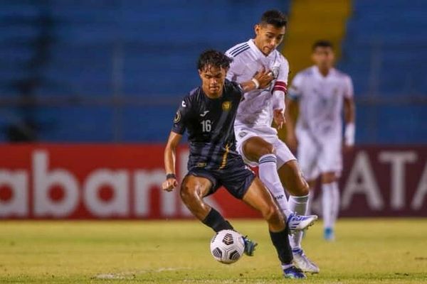 Two soccer players in action during a match, one in black and the other in white.