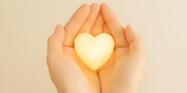 Hands holding a glowing heart symbolising care, compassion, and healing at Enerki Bowen and Massage.