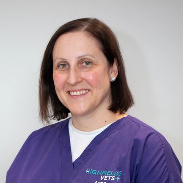 Anna Atkins, a veterinary surgeon with purple top with the Highfields Vets logo on, smiling.