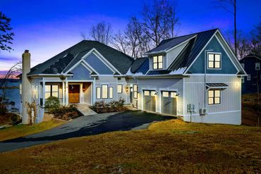 Modern house with blue siding at dusk.