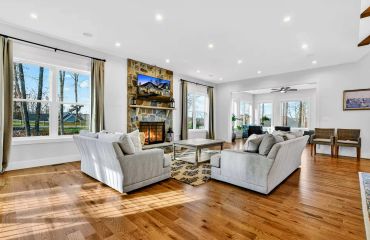 Lake Anna custom home interior with open concept living area and stone masonry fireplace.