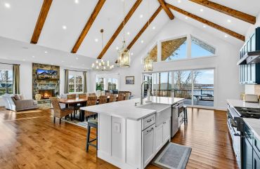  Custom kitchen installation with exposed structural beams and shaker cabinetry.