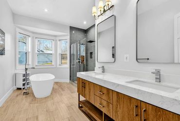 Lake Anna custom home architectural primary bathroom with freestanding tub and custom wood vanity.