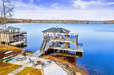 Architectural detail of a two-level boat dock with integrated mechanical lift on Lake Anna.