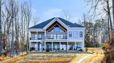 Lake Anna custom home exterior architecture viewed from the waterfront property line.
