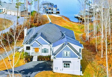 new construction home in Lake Anna showing complex roof framing and contrasting metal roof accents.