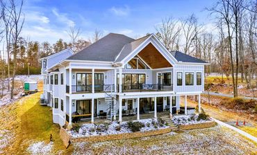Architectural rear elevation of a Lake Anna custom home w/ expansive glass