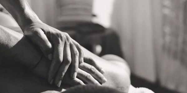 Hands giving a relaxing massage on a person's back.